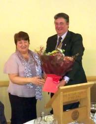 President Graham presents Mrs Sheila Davies with a bouquet after she had given our Christmas Message